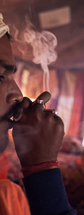 Sadhu smoking inside Anand Akhara tent
